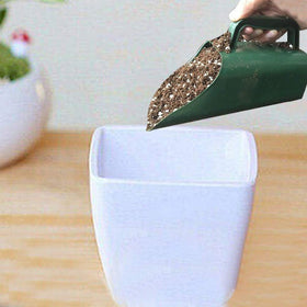 CALIDAKA soil scoop with durable plastic construction for everyday gardening use.