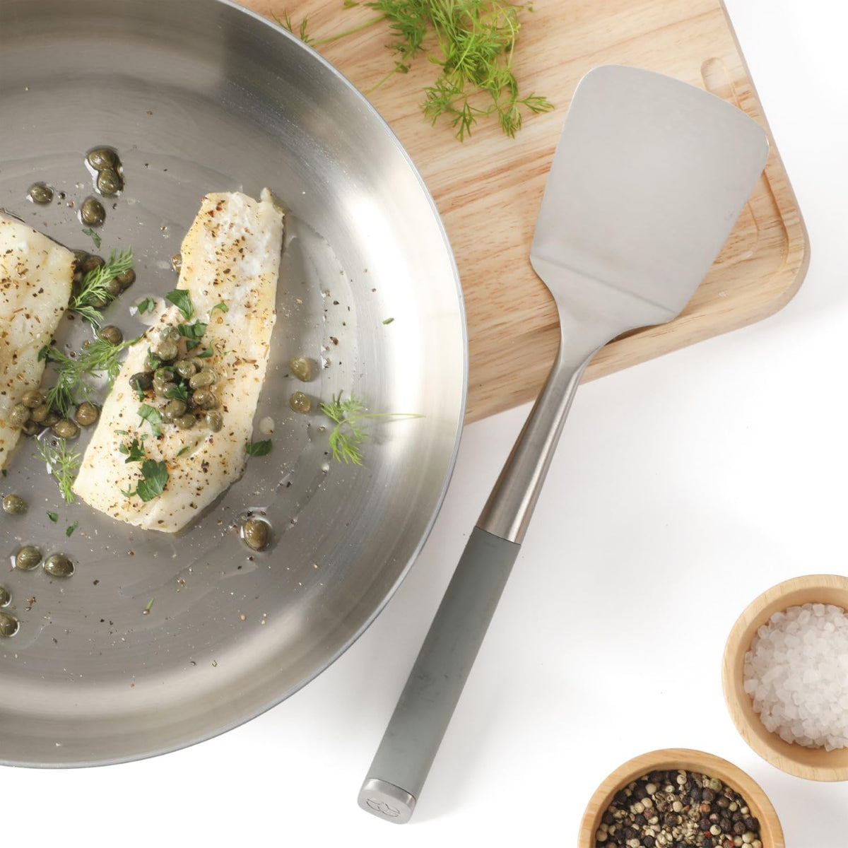 Calphalon Edge turner in use flipping food with controlled precision