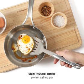 Calphalon Prime slotted turner with ergonomic grip for comfortable stirring.