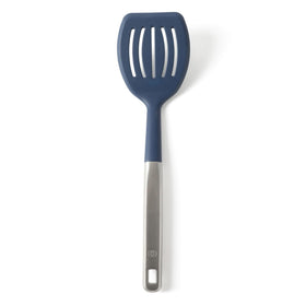 Calphalon Prime slotted turner with navy silicone head for gentle flipping of delicate foods.