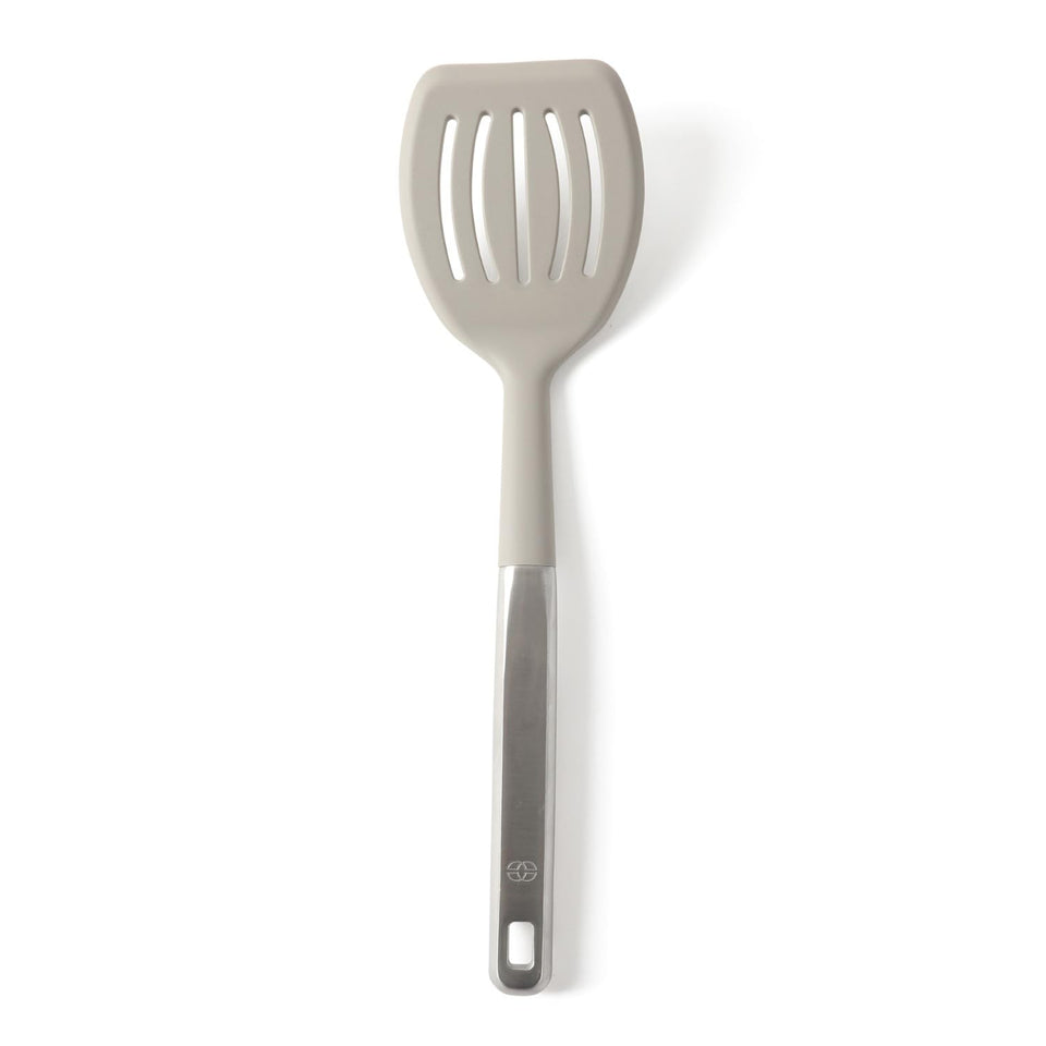 Calphalon Prime slotted turner with taupe silicone head lifting foods without scratching.
