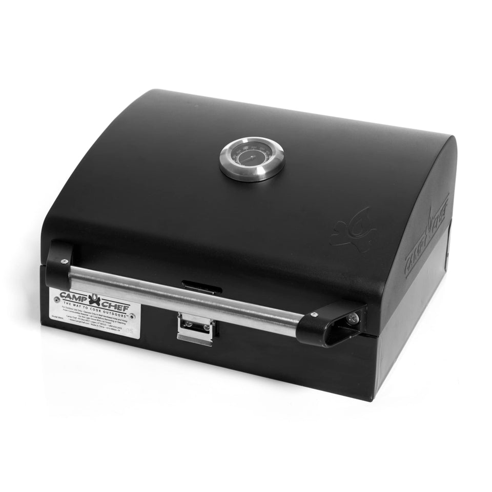 Camp Chef Deluxe BBQ Grill Box with lid locked demonstrates secure, portable cooking on the go