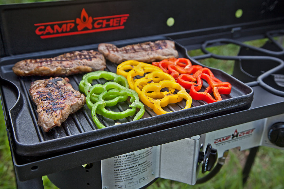 Camp Chef griddle ribbed side sears burgers and veggies with distinct marks.