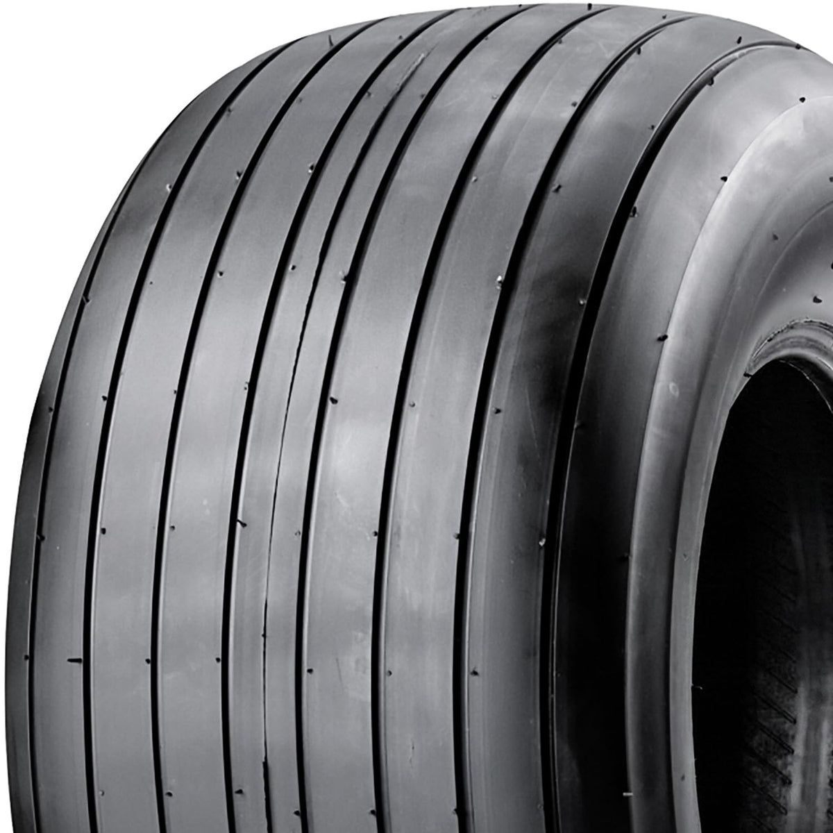 Carlisle Straight Rib tire tread detail highlighting ribbed contact on varied surfaces.