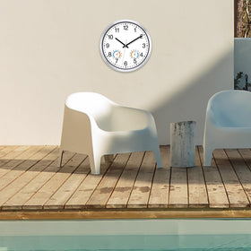 Caysie clock mounted in a patio setting for versatile outdoor use.
