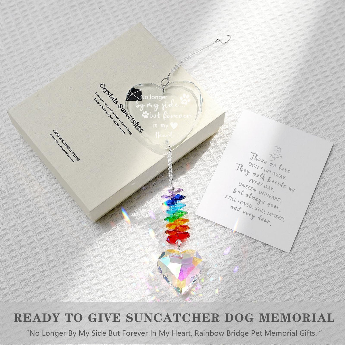 Ceegook dog memorial heart suncatcher in sunlight creating rainbow reflections.