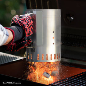 Char-Griller chimney starter trigger release in action, streamlining charcoal loading.