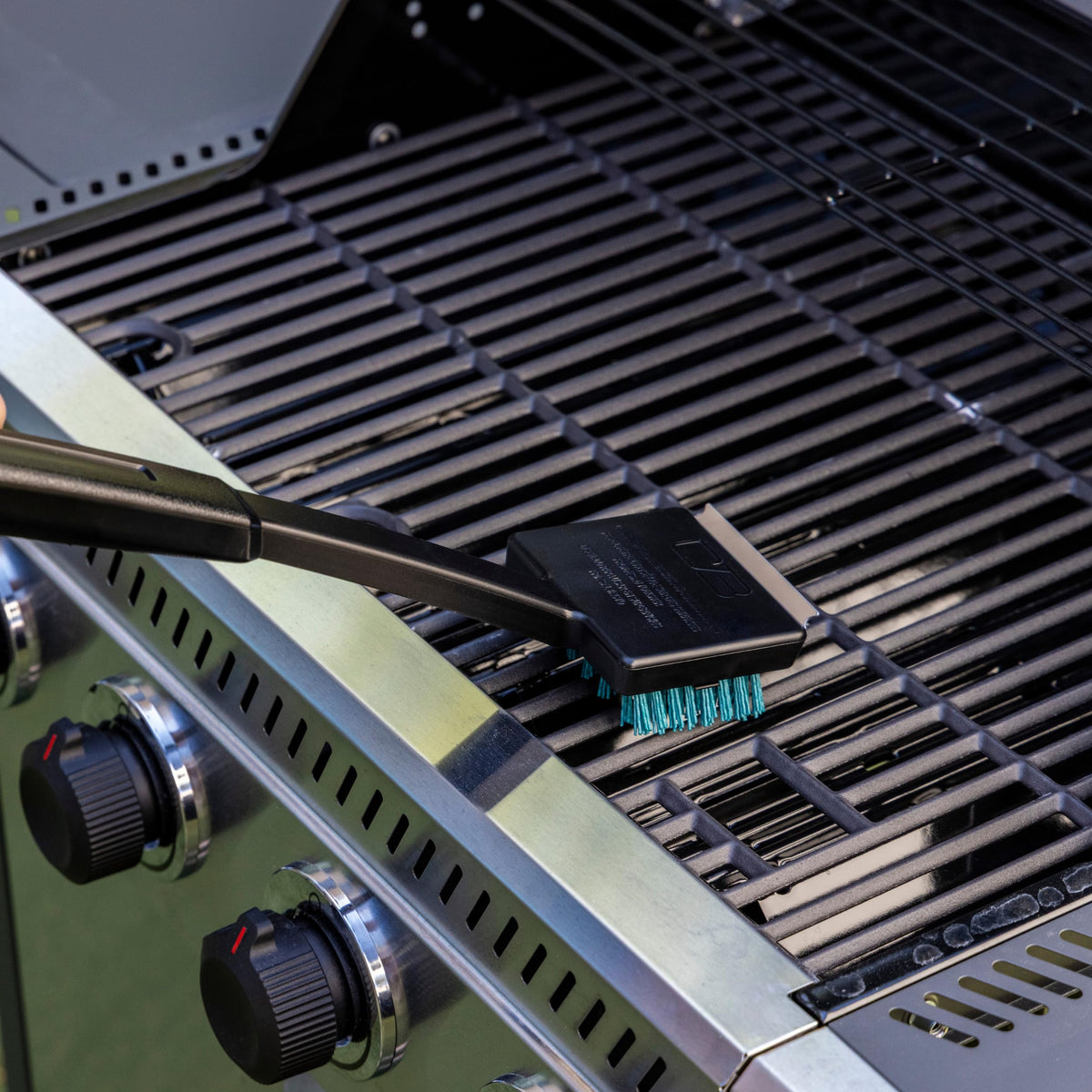 Charbroil built-in scraper on the grill brush for residue removal.