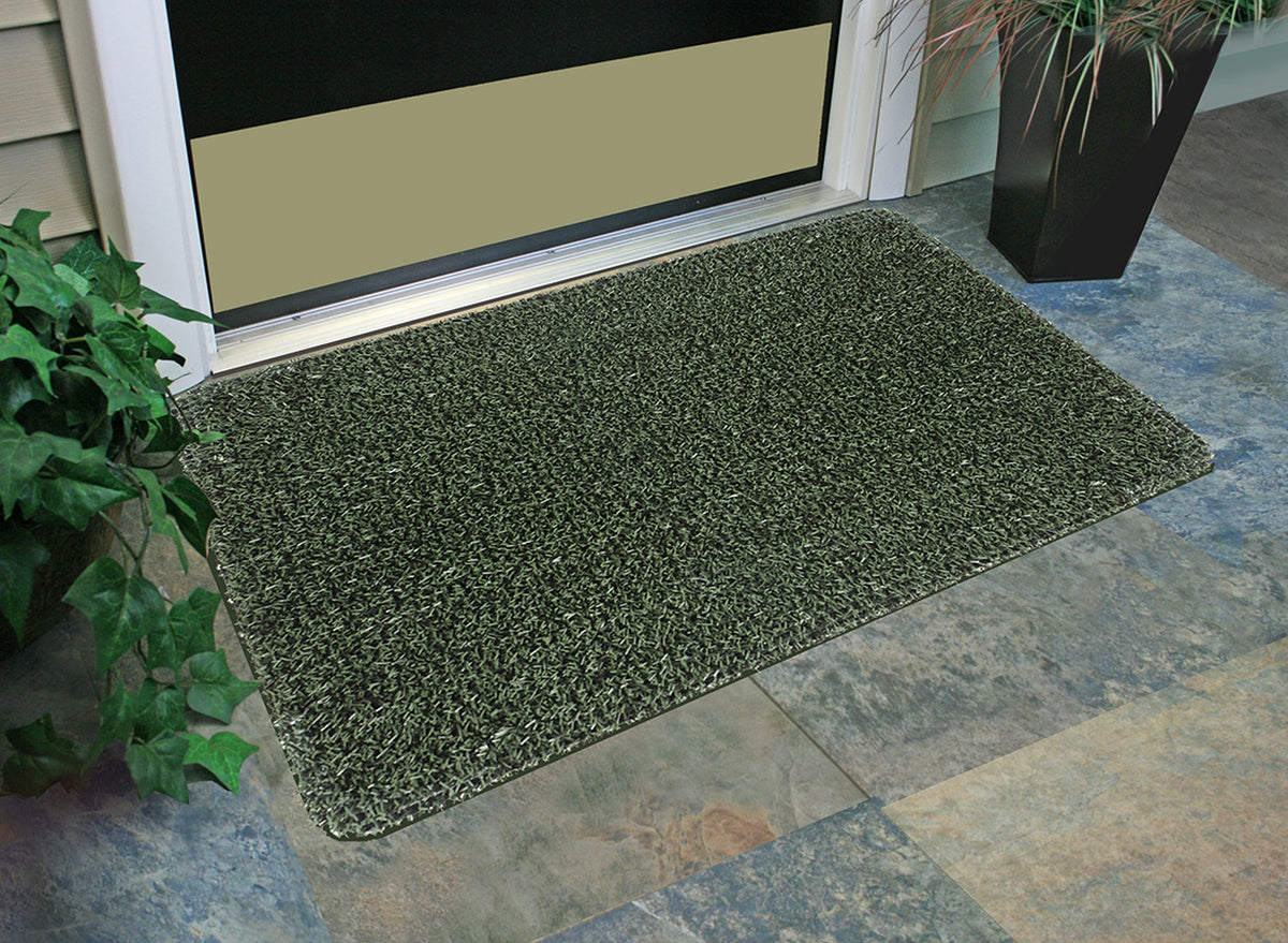 CLEAN MACHINE mat with grass-like blades scrapes shoes and traps dust beneath the surface.