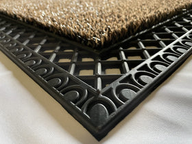 Clean Machine French Quarter doormat close-up showing blades capturing dirt.
