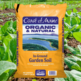 Coast of Maine Cobscook Blend being spread over a garden bed to improve soil quality.