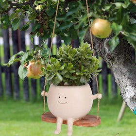 CONNOVA resin smiley planter showcases moving art in any space.