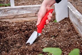 Corona Comfort Trowel in raised bed ideal for transplanting seedlings