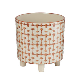 Creative Co-Op footed stoneware planter with abstract rust-white print elevates small herbs