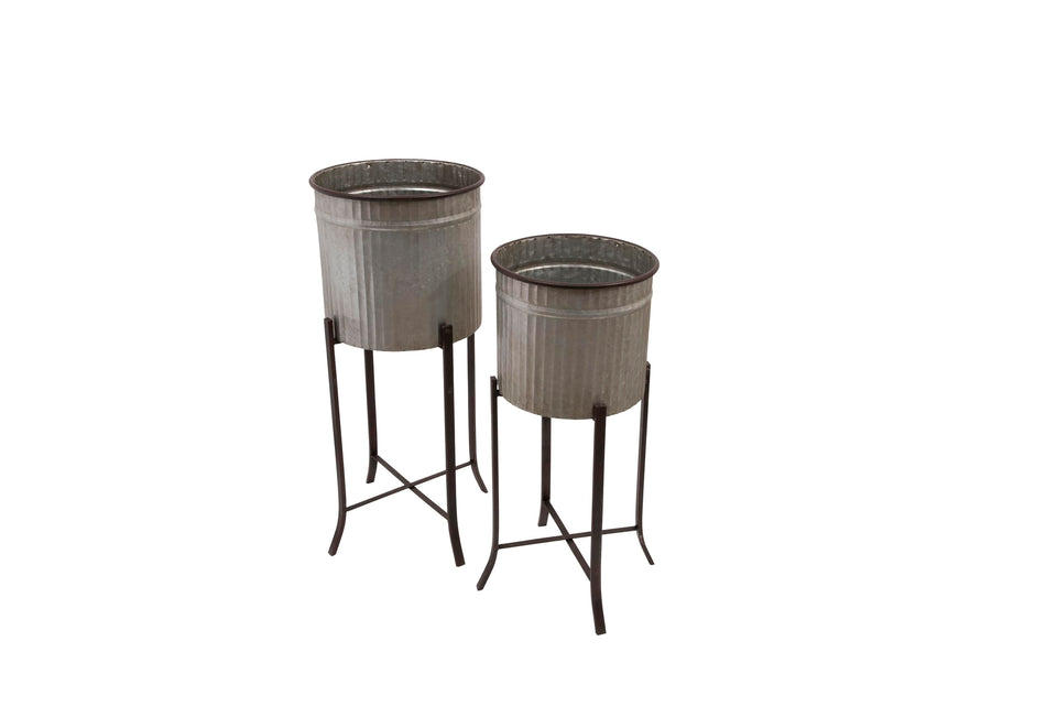Creative Co-Op iron planters on stands with round corrugated metal for indoor display.
