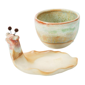 Creative Co-Op snail planter saucer-tray demonstrates water catchment protecting surfaces