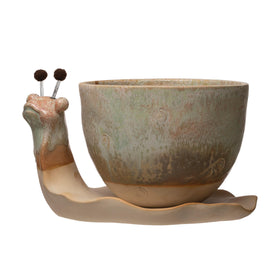 Creative Co-Op snail planter top-down reveals the drainage hole and saucer integration