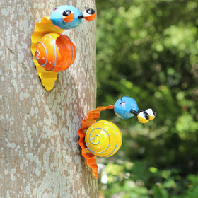 Cruis Cuka snail fence ornament brightens borders.
