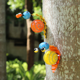 Cruis Cuka snail yard art orange adds playful color to patios.