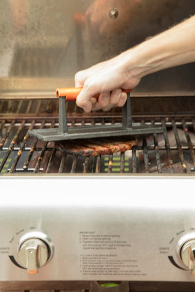 Cuisinart press searing steak with restaurant-style grill marks.