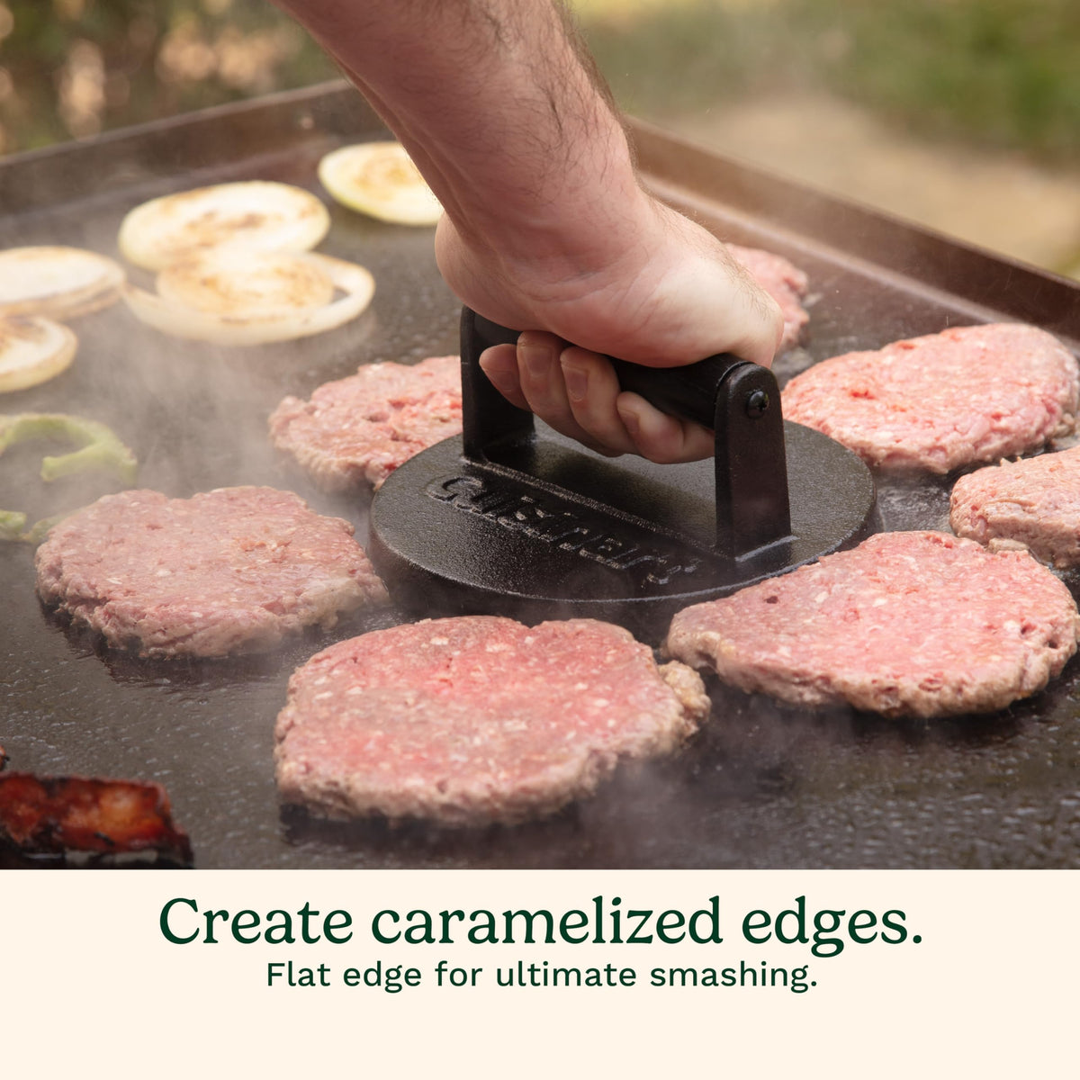 Cuisinart smash burger pressed onto a grill, showing versatility for griddles and grills.