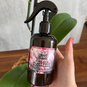 Cute Farms Orchid Plant Food Mist spray demonstrates even coverage for roots and soil.