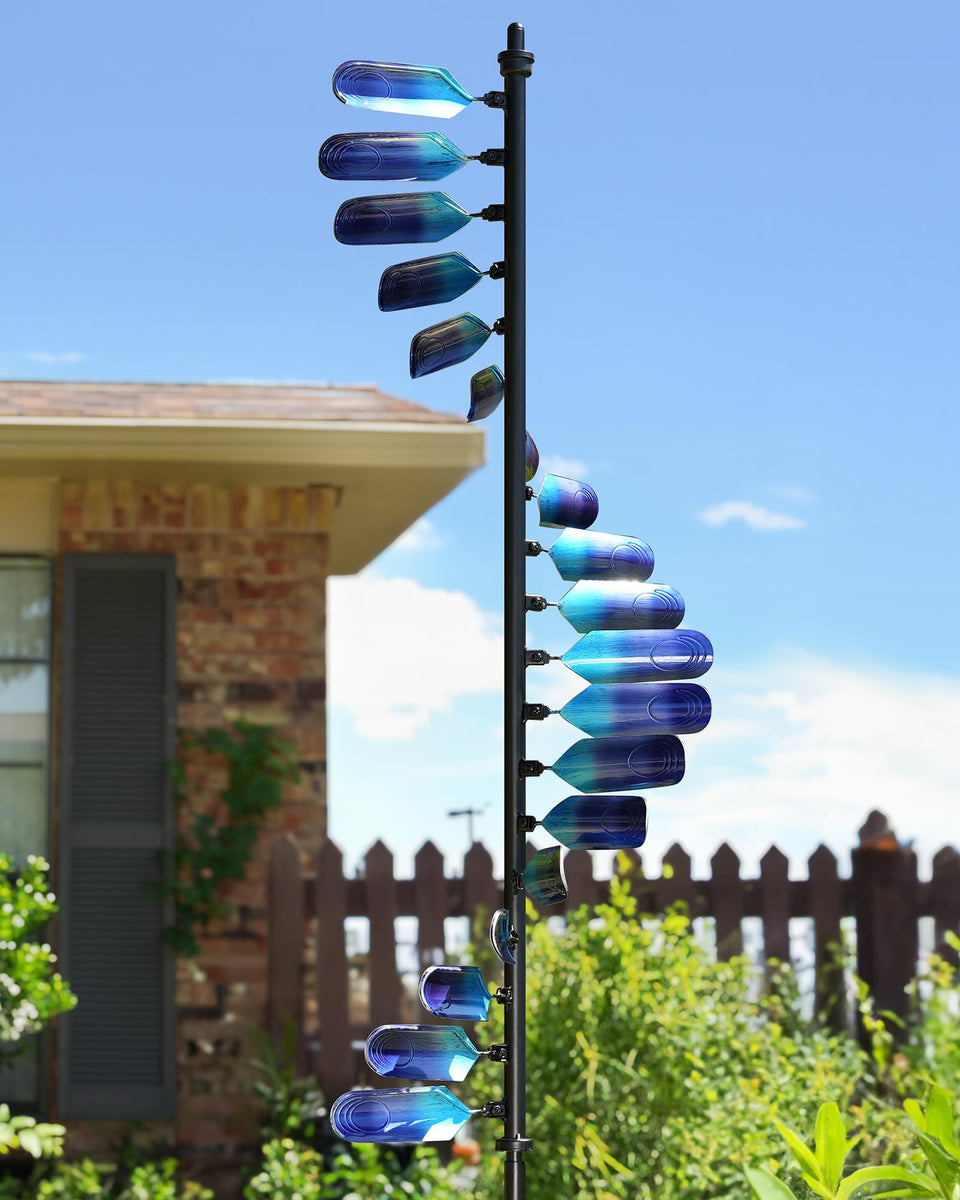 Cyan Oasis wind spinner with peacock spiral adding vibrant garden color