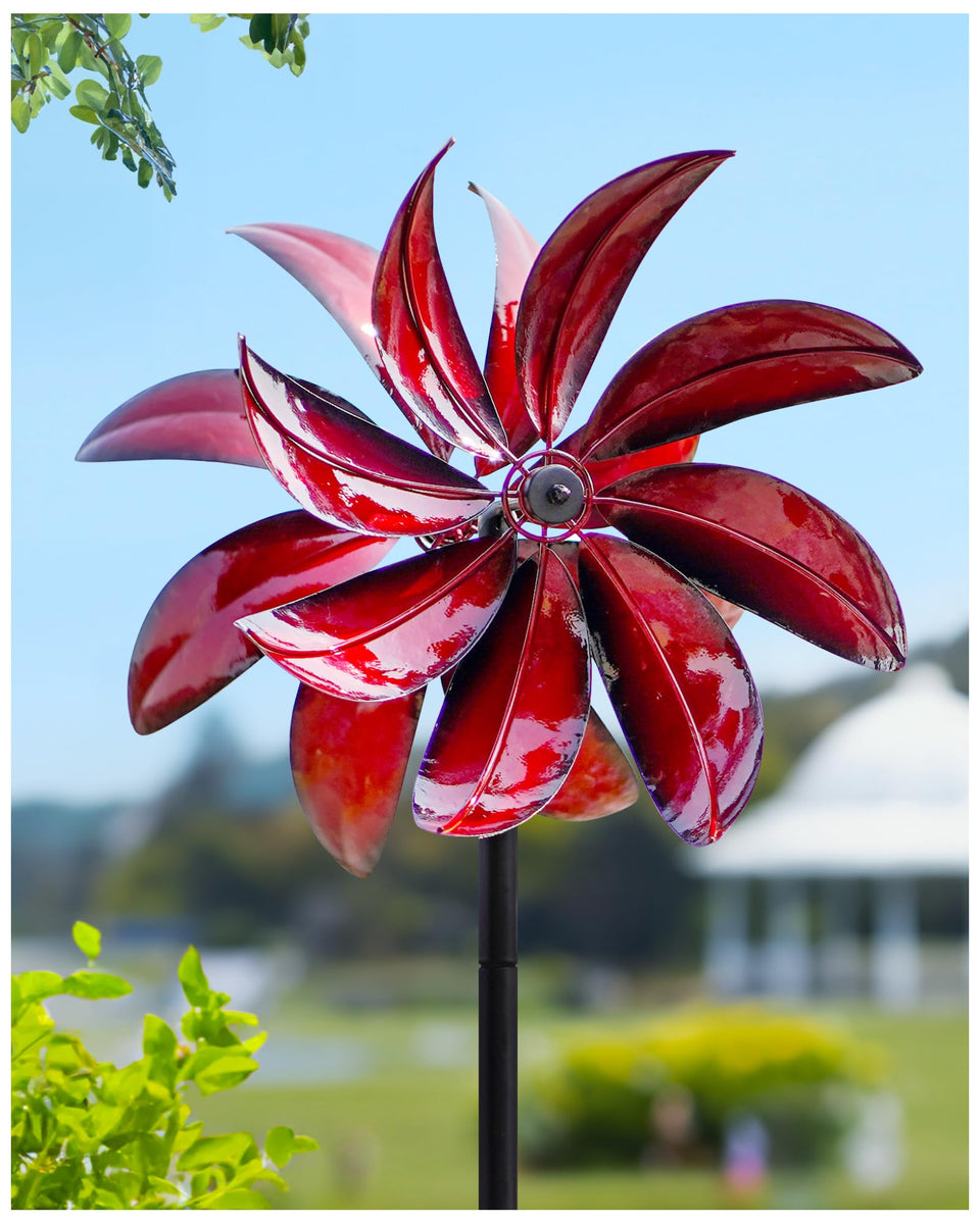 Cyan Oasis wind spinner in red metal design, vibrant garden focal point.