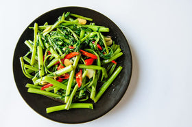 CZ Grain Kong Xin CAI seeds planted in a garden plot for fresh greens.