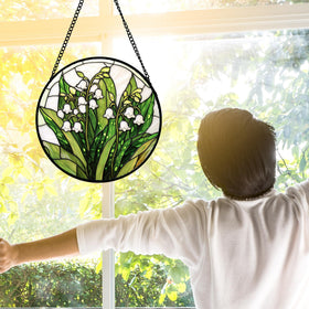 DASTOLL colorful sun catcher highlights green plant motif in sunlight.