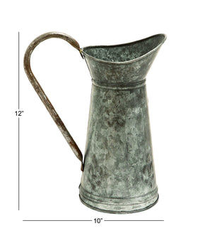 Deco 79 brown metal watering can pairs with greens for versatile decor.