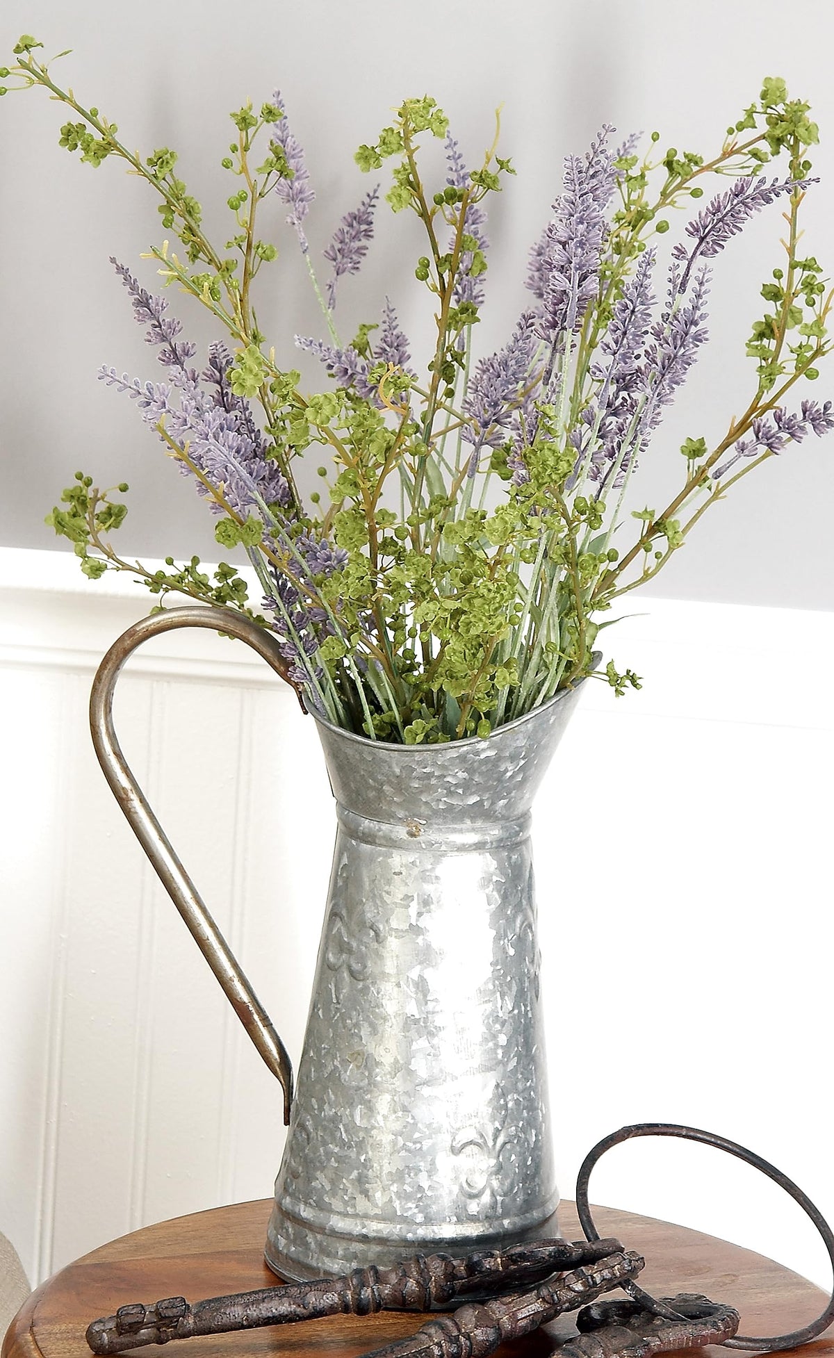 Deco 79 decorative planter water can blends vintage style with modern outdoor spaces.