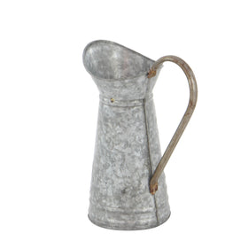Deco 79 galvanized finish watering jug enhances rustic charm in outdoor spaces.