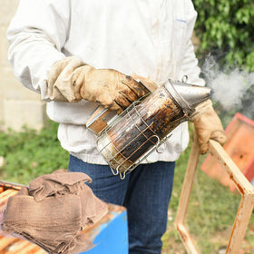 DECOHS burlap-smoker-fuel in smoker enhances calm, efficient hive management.