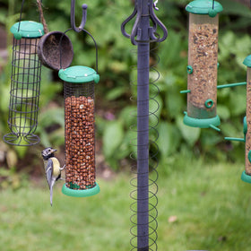 Close-up of Deecam barrier being mounted on a bird feeder pole for easy setup