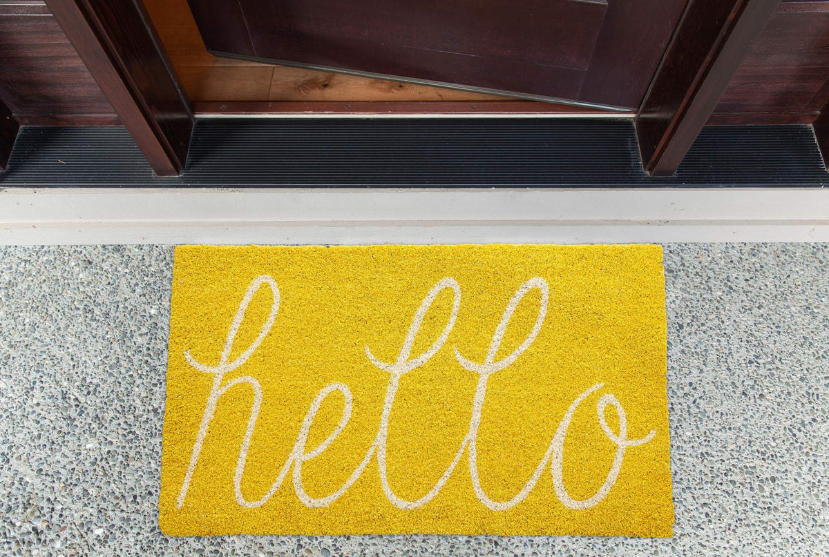 DII Hello coir doormat entryway yellow invites a clean entry.