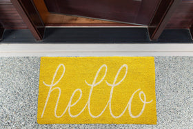 DII Hello coir doormat entryway yellow invites a clean entry.