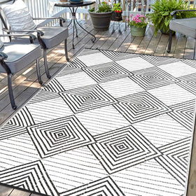 DiiKoo waterproof outdoor rug 6x9 folded for RV use, weatherproof and easy to clean.