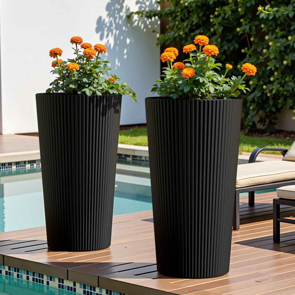 Diyfire tall planter in black with fluted design on a front porch that supports plants