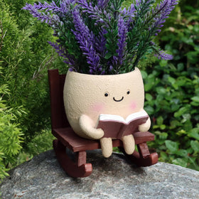 Dolkgy cute face planter on a rocking chair reads, ideal for indoor greenery lovers.