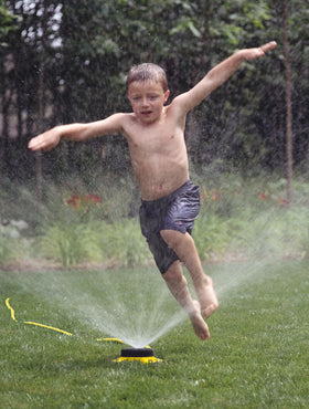 Dramm sprinkler with heavy-duty metal base for durable outdoor use.
