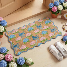 Dunzy Hydrangea Doormat with blue scalloped bow greets guests at the door.