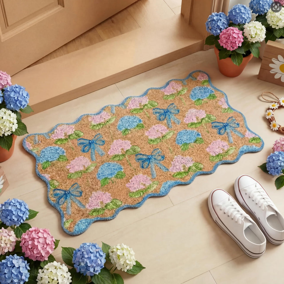 Dunzy Hydrangea Doormat with blue scalloped bow greets guests at the door.