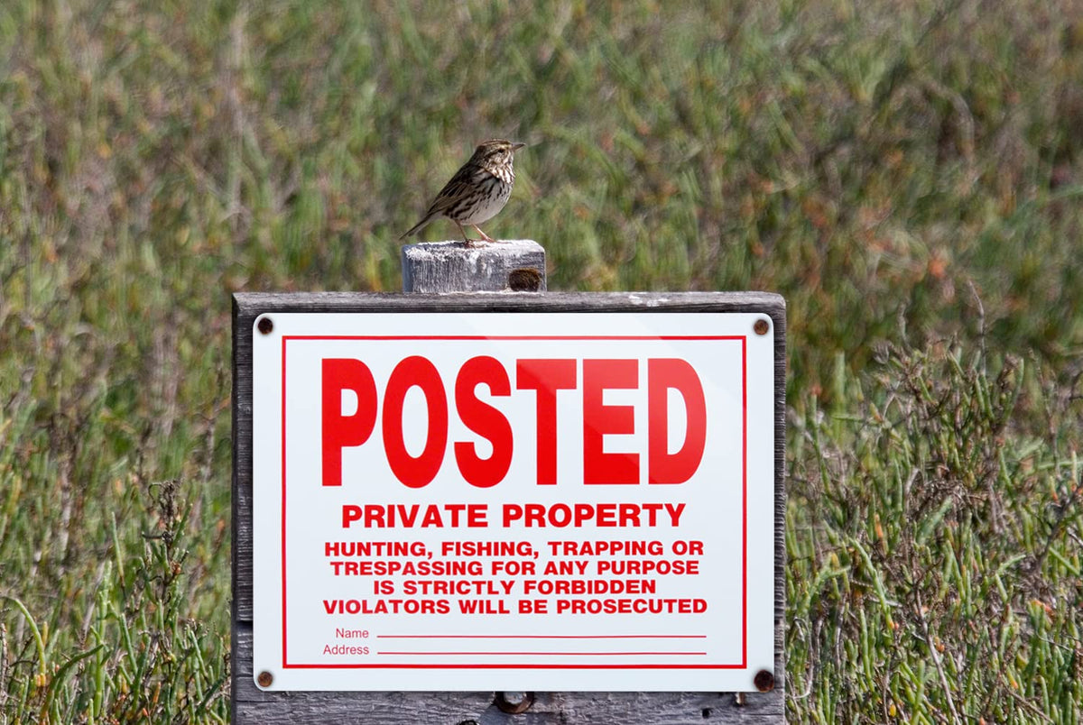 Dxyizus Signs private property sign mounted on a fence for high visibility.