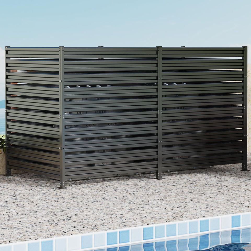 Dyemair metal privacy fence panels shield outdoor equipment and trash cans from view.