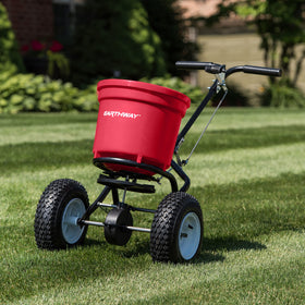 EarthWay 2150 walk-behind spreader in action across a lawn