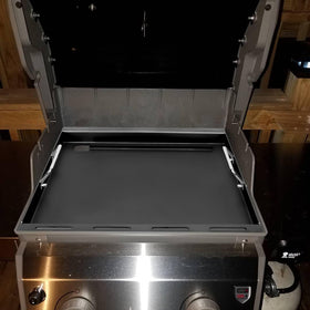 Large cooking area of EasiBBQ griddle plate ready for steaks and vegetables