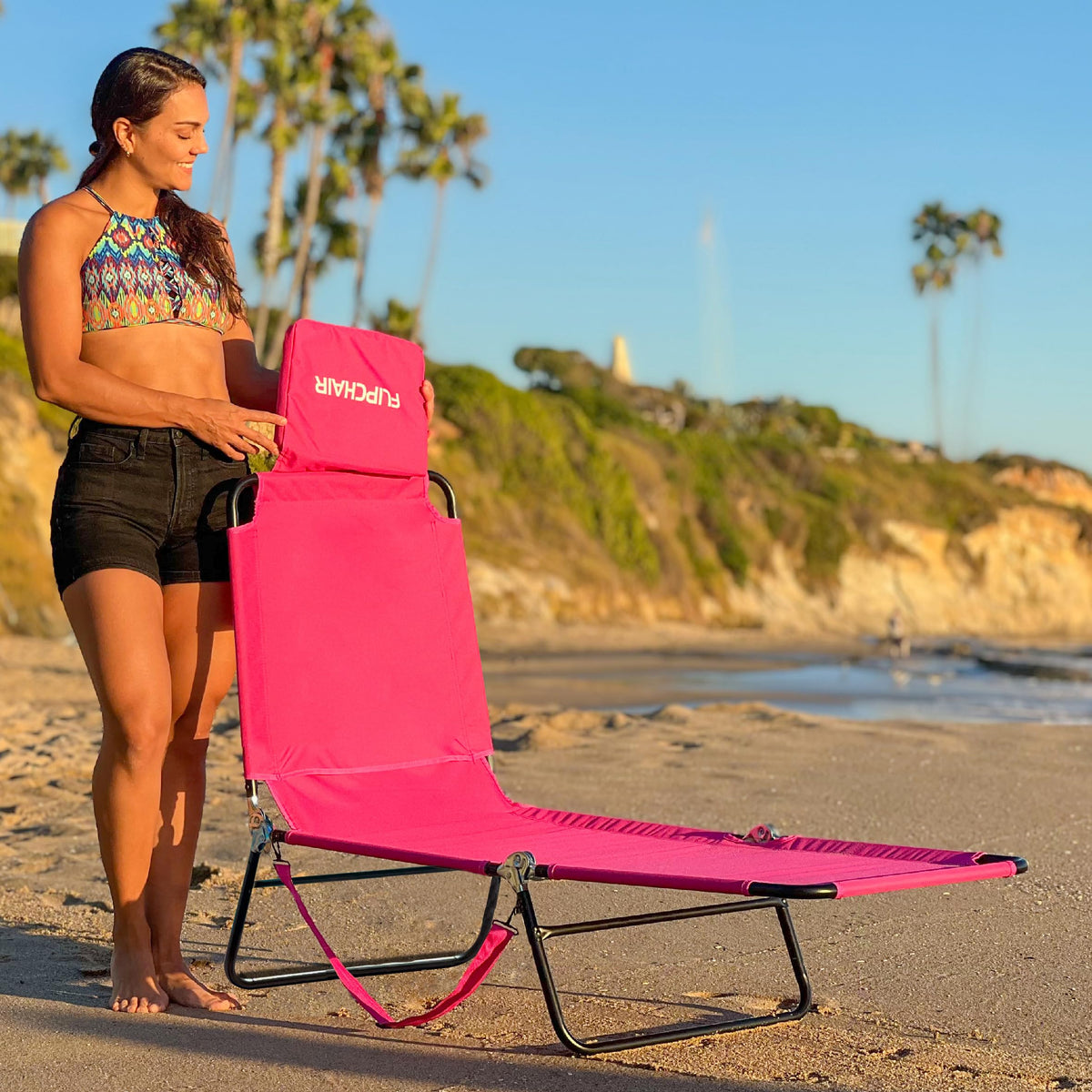 EASYGO PRODUCTS pink lawn chair at the beach for sun and relaxation