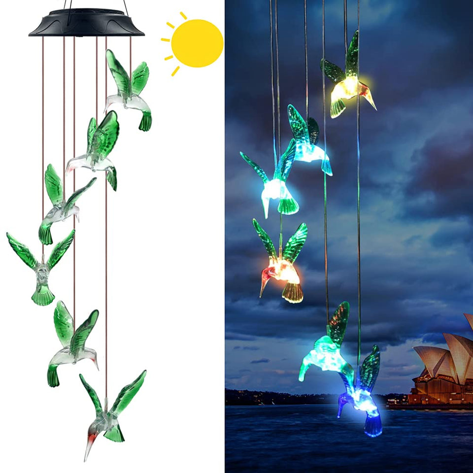 Eleven Direction Hummingbird Solar Chimes illuminate softly at dusk for magical garden ambiance.