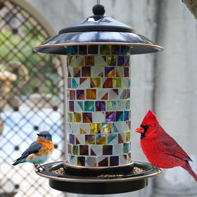 Elfonsol Solar Bird Feeder with sunset mosaic shines at dusk, inviting birds to feed.